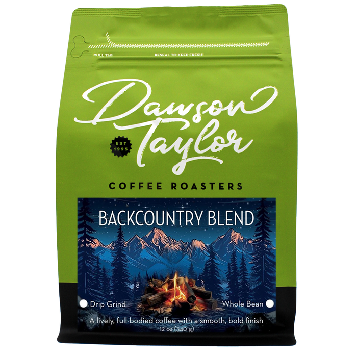 Backcountry Blend coffee bag with a mountains and campfire label on bright green packaging.