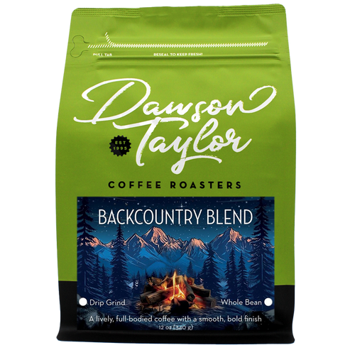 Backcountry Blend coffee bag with a mountains and campfire label on bright green packaging.
