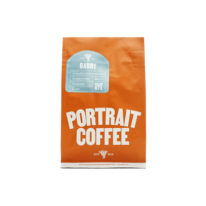 Bright orange Portrait Coffee bag labeled BARRY with a light blue tasting notes sticker