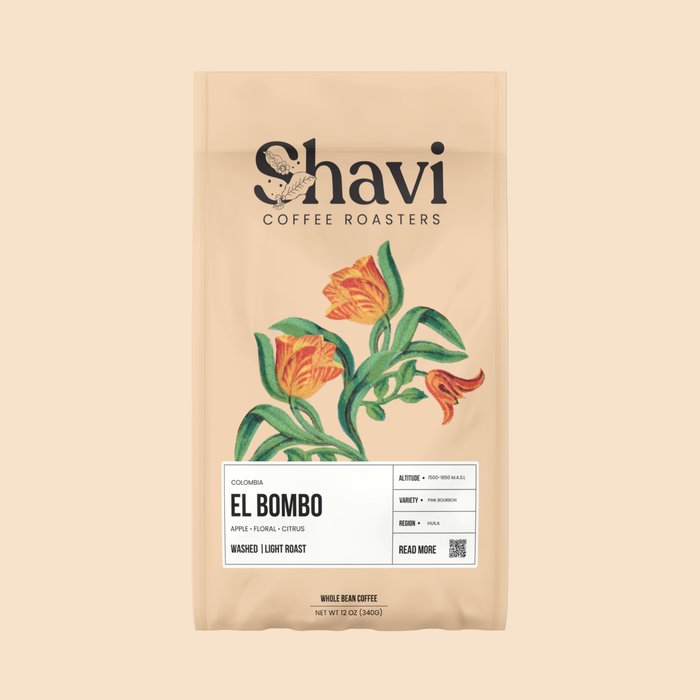 Partial view of a beige El Bombo coffee bag by Shavi Coffee Roasters with a botanical leaf design