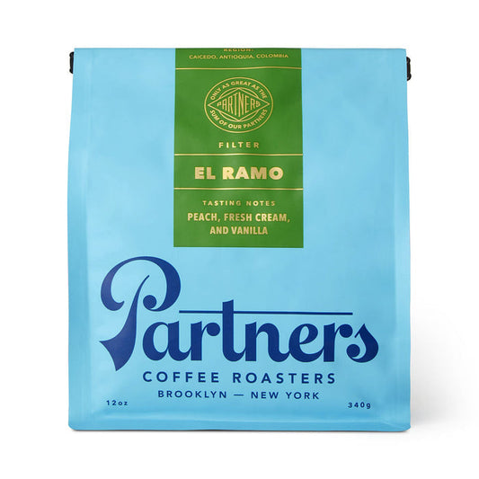 Blue Partners coffee roasters bag labeled El Ramo with tasting notes peach fresh cream and vanilla.