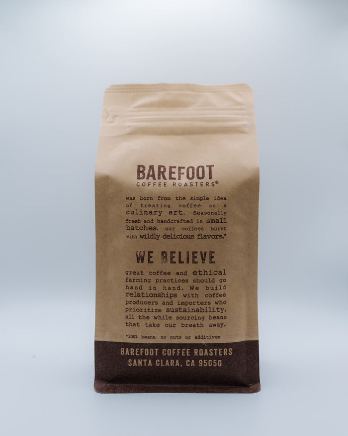 Front view of a brown Barefoot Coffee Roasters paper bag against a pale blue background