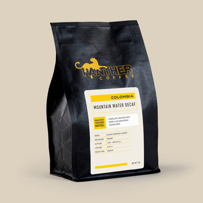 Colombia Mountain Water Decaf bag from Panther Coffee with a yellow Mountain Water label
