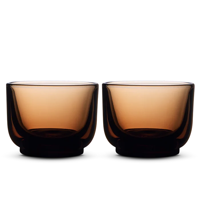 Pair of copper amber Fellow Pirch espresso shot glasses side by side