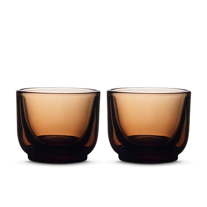 Pair of deep amber Fellow Pirch espresso shot glasses side by side