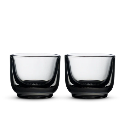 Pair of Fellow Pirch espresso shot glasses with pale green tinted bowls and dark bases