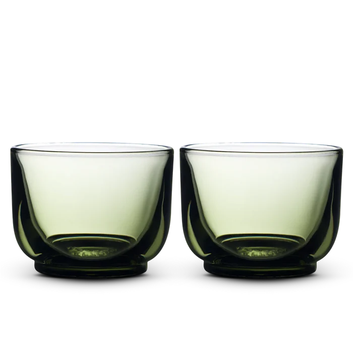 Pair of Fellow Pirch espresso shot glasses with green tinted bowls and dark bases