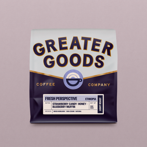 Close-up of a Greater Goods coffee bag showing bold typography and a cup logo on a pink backdrop