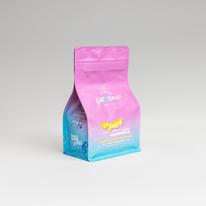 Pink Guatemala La Folie coffee bag shown with a teal to blue gradient background.