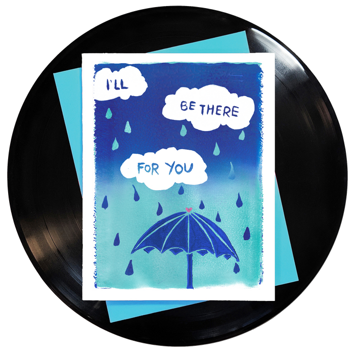 ombre blue and turquoise fade with white rain clouds & turquoise and blue raindrops and a blue umbrella with a pink heart at the top featuring song lyrics from the friends theme songs that say I'll be there for you
