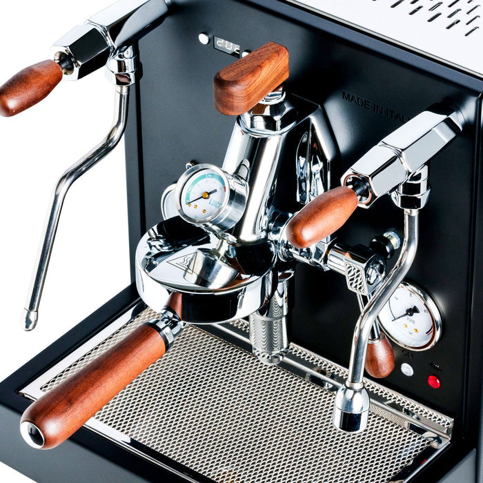 LUCCA E61 espresso machine front panel with wood trimmed handles, chrome levers, and a pressure gauge.