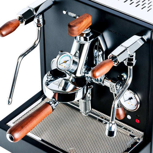LUCCA E61 espresso machine front panel with wood trimmed handles, chrome levers, and a pressure gauge.