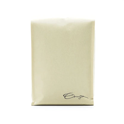 Monarch coffee bag in light kraft with handwritten signature at the bottom