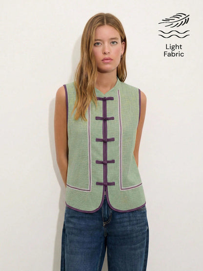 Nöista Sleeveless Top In A Soft Chambray-Blue Tone With Mandarin Collar And Chinese Button Front.Contrast Purple Trim Decorative Piping, Everyday Styling.