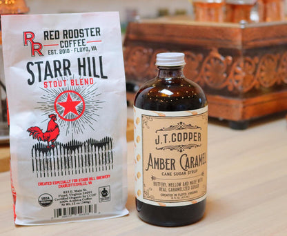 Starr Hill Stout Blend bag beside a J T Copper Amber Caramel Cane Sugar Syrup bottle on a wooden counter