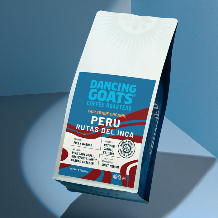 Peru Rutas Del Inca coffee bag tilted against a blue backdrop with red banner and white label details