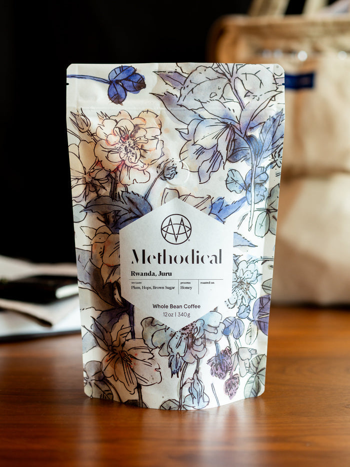 Methodical Rwanda Juru coffee bag with white floral design and label