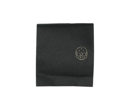 Black coffee bag featuring a gold skull logo and subtle brand mark