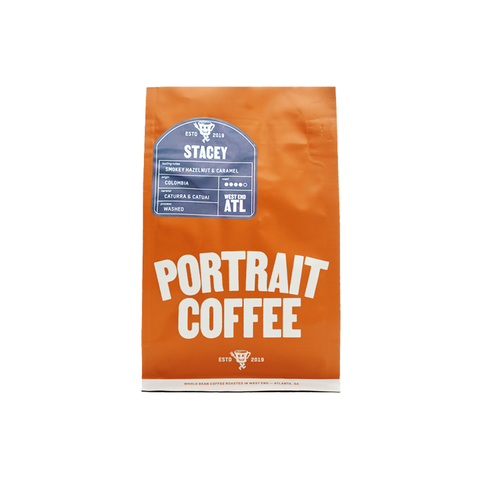 Orange STACEY coffee bag standing upright with a blue label and bold Portrait Coffee typography