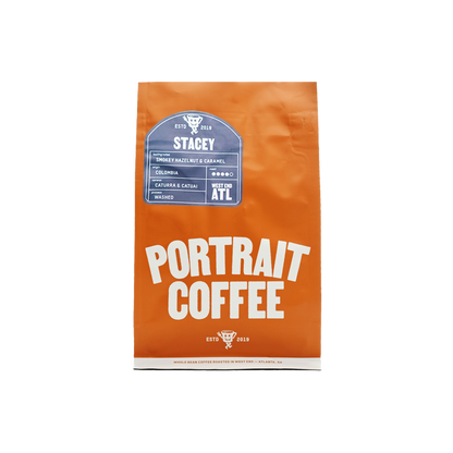 Orange STACEY coffee bag standing upright with a blue label and bold Portrait Coffee typography