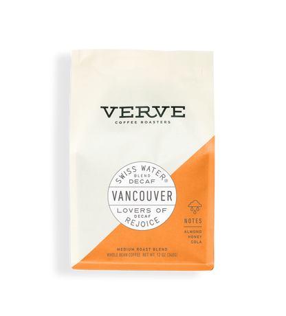 Vancouver Swiss Water Decaf whole bean coffee bag with white upper portion and orange diagonal panel and Vancouver seal
